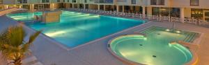 a large swimming pool in the middle of a building at Hotel Terme Marine Leopoldo II TERME & SPA in Marina di Grosseto