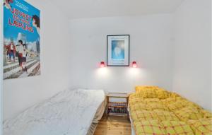 a bedroom with two beds and a picture on the wall at Amazing Home In Hjby With Wifi in Højby