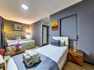 a hotel room with two beds and a table at Hotel Mara İstanbul in Istanbul