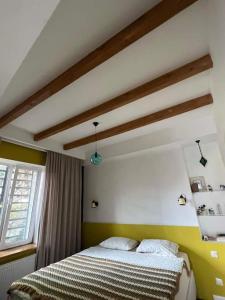 a bedroom with a bed and a window at Vake View Villa in Tbilisi City