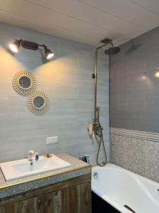 a bathroom with a sink and a bath tub at Vake View Villa in Tbilisi City