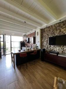 a living room with a bar and a stone wall at Vake View Villa in Tbilisi City