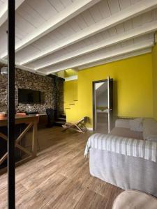a bedroom with a bed and a yellow wall at Vake View Villa in Tbilisi City