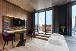 a room with a table and chairs and a large window at Onyx Luxury Budapest in Budapest
