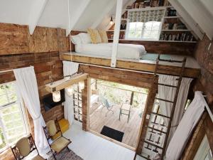 an overhead view of a tiny house with a bedroom at Chelsea Manor in Kini Bay