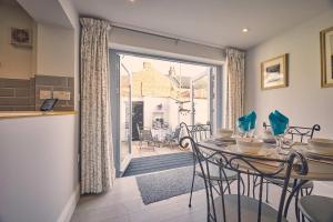 a kitchen and dining room with a table and chairs at Host & Stay - Roselyn By The Sea in Newbiggin-by-the-Sea
