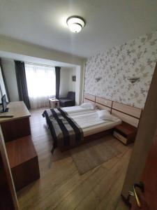 Postel nebo postele na pokoji v ubytování Hotel Stogu
