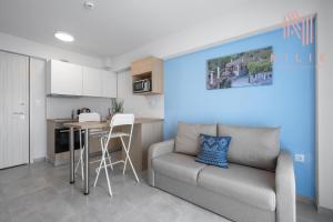 a living room with a couch and a kitchen at Ouranos, Nilie Hospitality MGMT in Nikiti