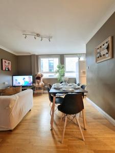 a living room with a table and a couch at 3 bedroom flat near Russel Sq in London