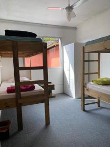 a room with two bunk beds and a ceiling at Amares Hostel in Florianópolis