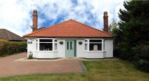 a small white house with an orange roof at The Sidings in Sheringham