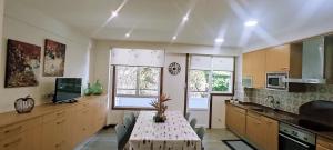 a kitchen with a table and two windows in it at AMANE Lekeitio, Parking Incluido in Lekeitio