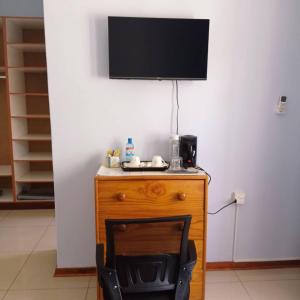 a wooden table with a television on top of it at WaterBerry Guest House in Kasane