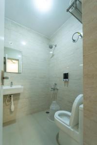 a bathroom with a toilet and a sink at Hoppers Stop Yelahanka in Bangalore