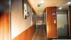 a hallway in a building with wooden walls at Airport GoldenTulip Hotel in Lagos
