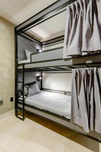 Krevet ili kreveti na sprat u jedinici u okviru objekta Cama en Habitación Compartida Mixta