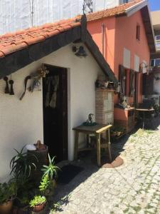 een huis met een deur en een tafel ervoor bij A Barraquinha 30 steps from sea in Apúlia