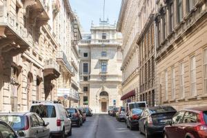 a city street with cars parked in front of buildings at Central Relax Boutique Suites in Budapest
