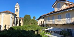a building with a clock tower in the background at FWL The Lake Suite in Arona