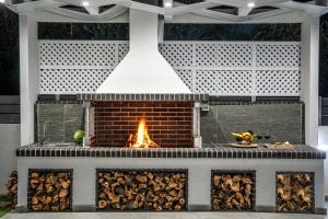 a fire pit with a brick fireplace at AJ - Seaview Private Villa in Tsilivi