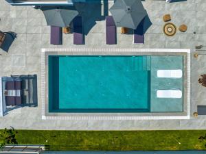 蒂錫利維的住宿－AJ - Seaview Private Villa，享有带遮阳伞的游泳池的顶部景致