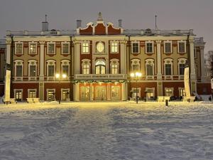 a large building with snow in front of it at Penthouse Kadriorg in Tallinn