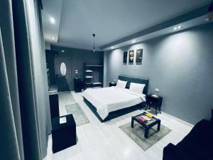 Rove Residence New Cairo في القاهرة: غرفة نوم فيها سرير وطاولة فيها