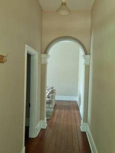an empty hallway with an archway in a house at North Perth Stylish Abode CBD in Perth