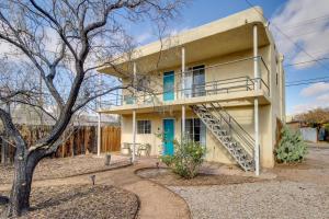 a yellow house with a staircase in front of it at Cozy Albuquerque Apartment Less Than 1 Mi to Downtown! in Albuquerque