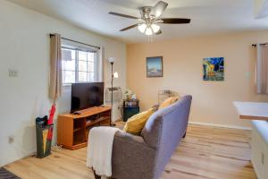 a living room with a couch and a television at Cozy Albuquerque Apartment Less Than 1 Mi to Downtown! in Albuquerque