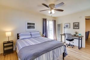 a bedroom with a bed with a ceiling fan and a desk at Cozy Albuquerque Apartment Less Than 1 Mi to Downtown! in Albuquerque