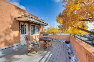 een houten terras met een tafel en een stoel bij Albuquerque Oasis with Patio, Deck and Gas Grill! in Albuquerque