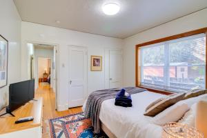 a bedroom with a bed and a large window at Silver Hill Apartment Near UNM Campus! in Albuquerque