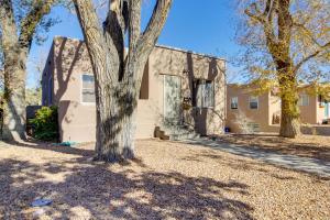 a house with a tree in front of it at Silver Hill Apartment Near UNM Campus! in Albuquerque