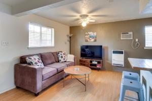 a living room with a couch and a tv at Charming Albuquerque Apartment Near Old Town! in Albuquerque