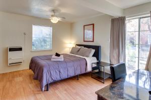 a bedroom with a bed with a cat sitting on it at Charming Albuquerque Apartment Near Old Town! in Albuquerque
