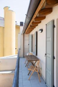 a table and chairs on the balcony of a building at Private Parking, Two Bedrooms & Two Bathrooms - Elegant Apartment in Old Town in Udine