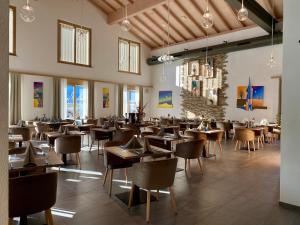 a restaurant with tables and chairs in a room at Boutique hôtel Corbetta in Les Paccots