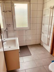 a bathroom with a sink and a window at Extertal-Ferienpark - Premium Ferienhaus Sauna Wandern #56a in Extertal