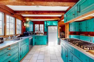 a kitchen with blue cabinets and a white refrigerator at The Swallow Hill Manor in Franklin