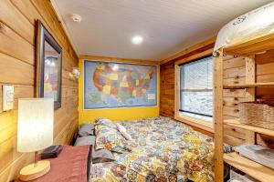 a small bedroom with a bed in a cabin at Sugarloaf Valley Escape in Carrabassett