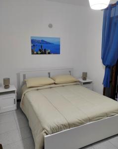 a bedroom with a large bed and two night stands at Holiday home Mennulita in Lipari