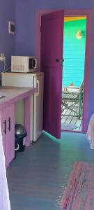 a room with a colorful room with a table and a door at Cat Nap Cottage in Bettyʼs Bay +28 photos