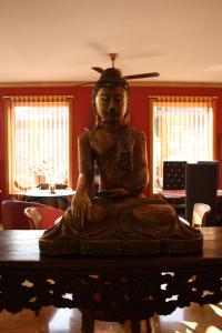 a statue sitting on a table in a room at Hotel Kerala in San Esteban de Pravia