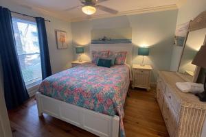 a bedroom with a bed and two lamps and a window at Driftwood Villa - 280 in Edisto Beach