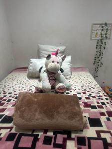 a stuffed animal sitting on top of a bed at Amazibuko Estate in Durban