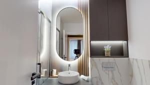a bathroom with a sink and a mirror at Quiet Luxury Home 1 - home & office in Zalău +26 photos