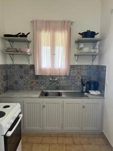 a kitchen with a sink and a window at Villa Flower in Skiathos