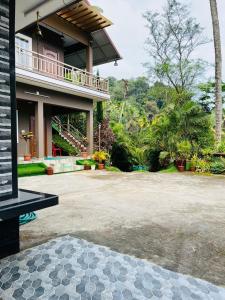 a house with a porch and a patio at Linn View Home Stay Munnar in Munnar