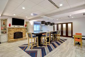 a large living room with a table and chairs at Hampton Inn Cortland in Cortland